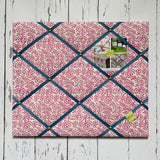 Patterned memo board with decorative items on a wooden surface
